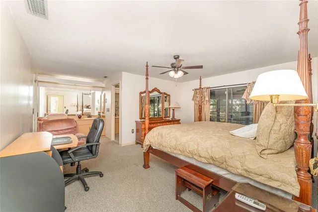 a bed room with a bed and chair