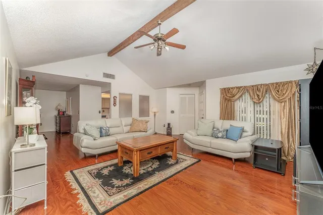 a living room with furniture a rug and a window