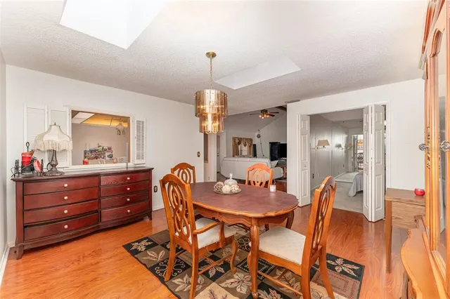 a dining room with furniture and wooden floor