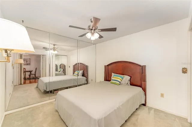 a bedroom with bed and a chandelier