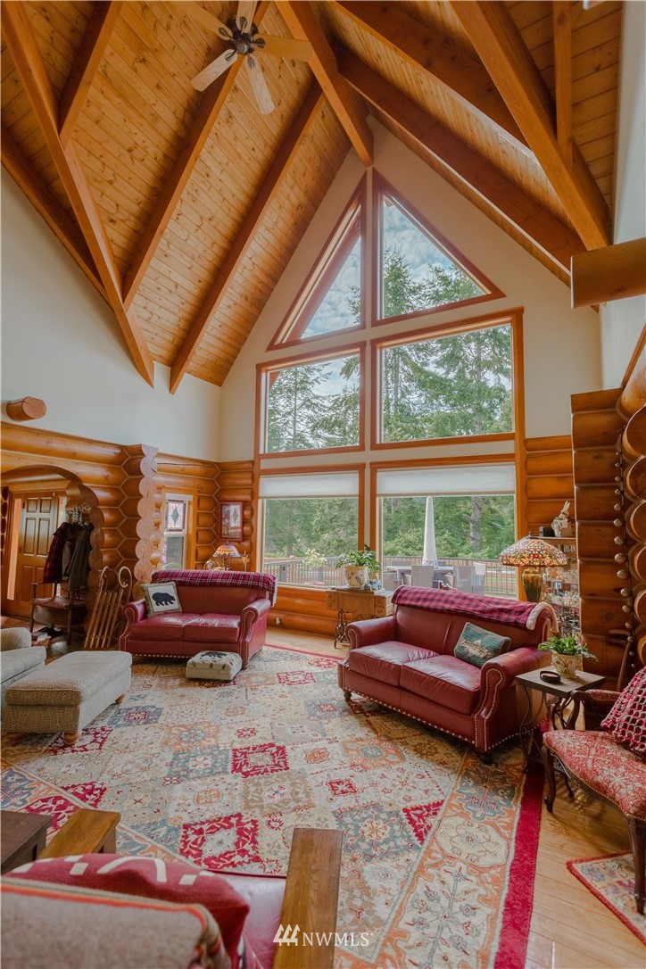 12057 Havekost Road Anacortes, WA 98221 - Photo 16 of 40 a living room with furniture and a floor to ceiling window