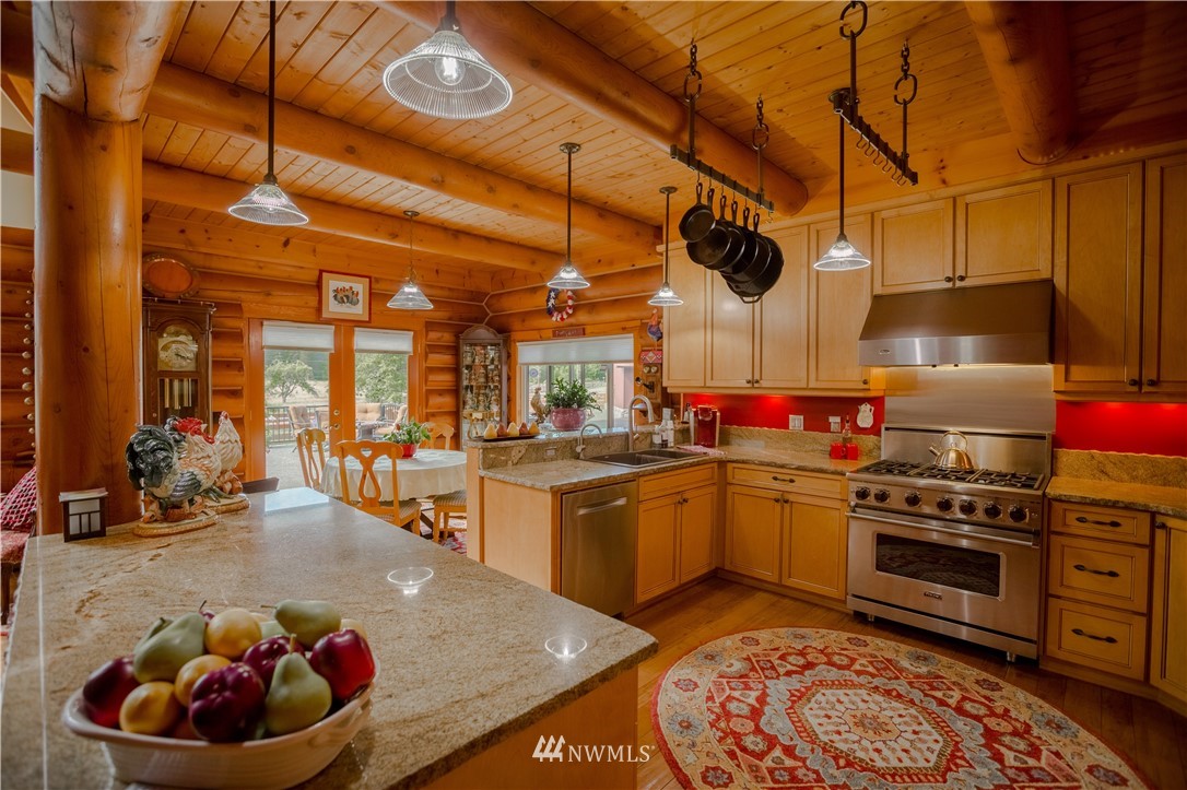 12057 Havekost Road Anacortes, WA 98221 - Photo 20 of 40 a kitchen with stainless steel appliances granite countertop a sink a stove and a wooden floors