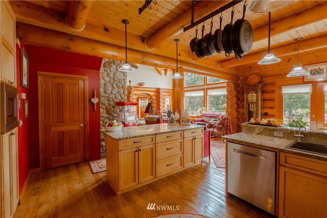 12057 Havekost Road Anacortes, WA 98221 - Photo 23 of 40 a kitchen with stainless steel appliances granite countertop a stove a sink and a refrigerator