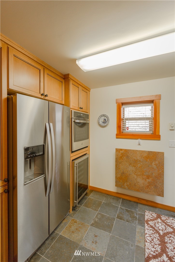 12057 Havekost Road Anacortes, WA 98221 - Photo 25 of 40 a kitchen with stainless steel appliances granite countertop a refrigerator and a sink