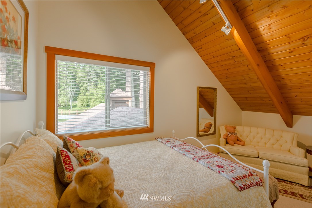 12057 Havekost Road Anacortes, WA 98221 - Photo 30 of 40 a bedroom with a bed and a large window