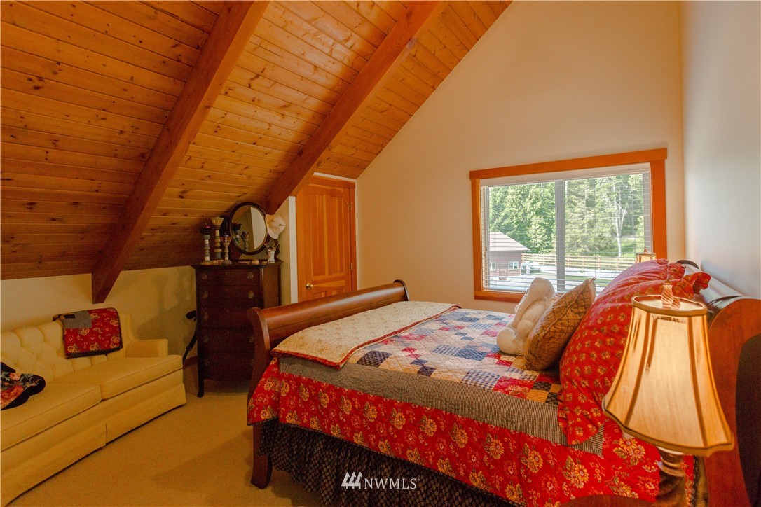 12057 Havekost Road Anacortes, WA 98221 - Photo 31 of 40 a bedroom with a bed and a window