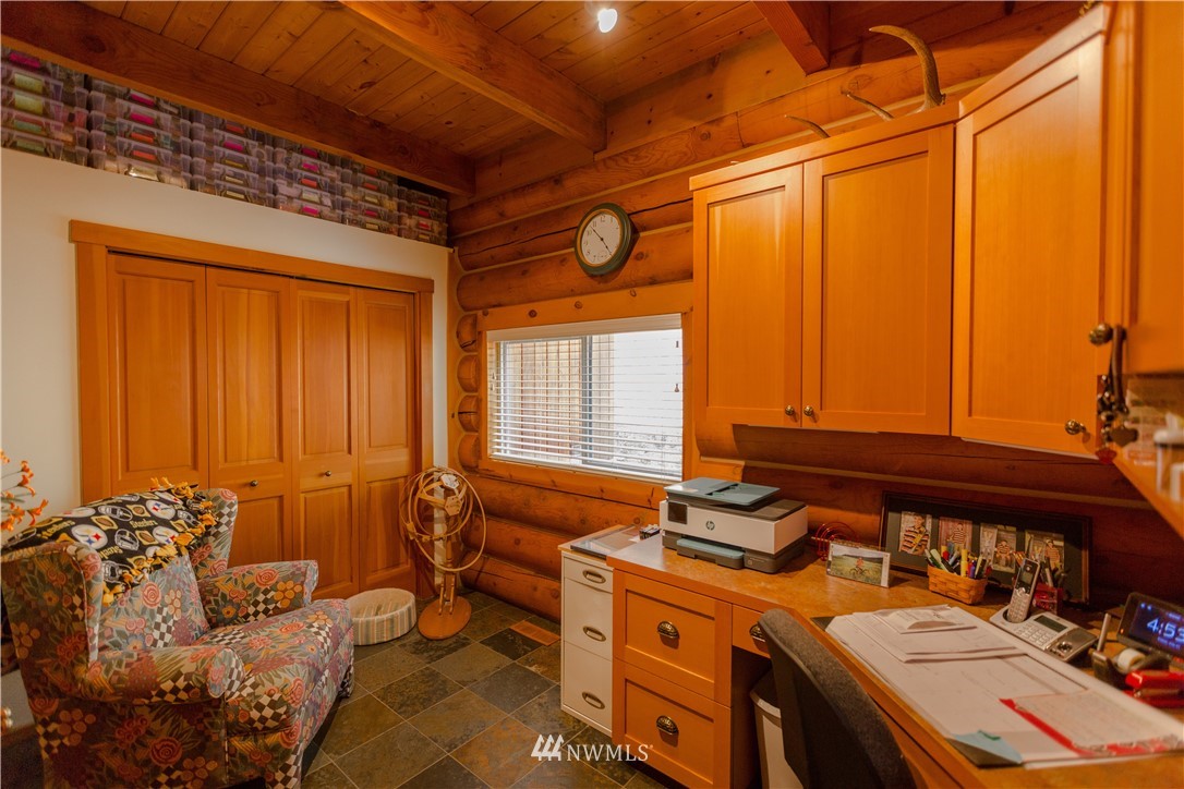 12057 Havekost Road Anacortes, WA 98221 - Photo 32 of 40 a bed room with a bed and a chair