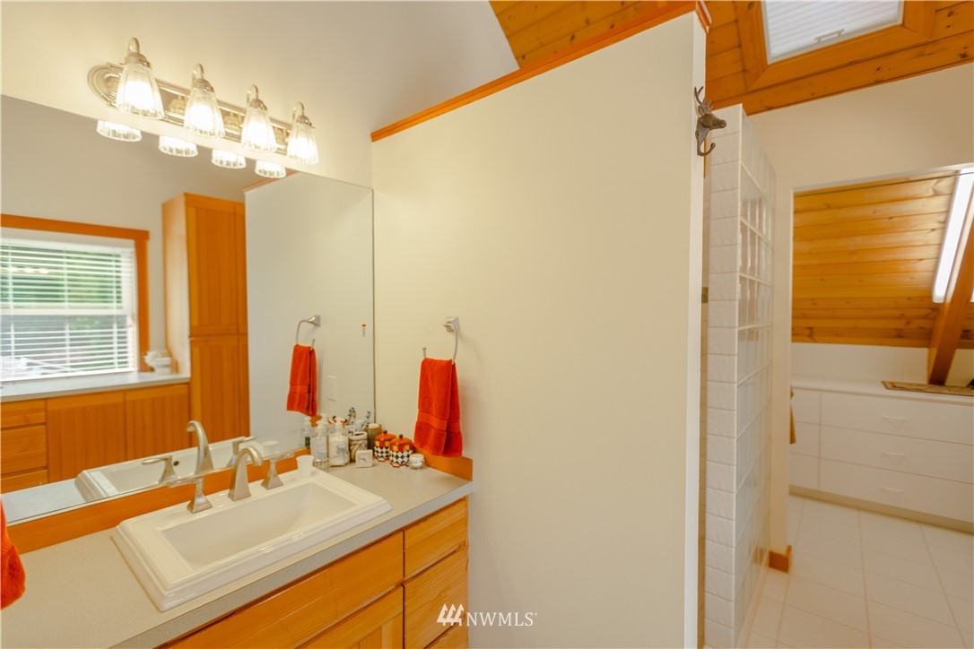 12057 Havekost Road Anacortes, WA 98221 - Photo 34 of 40 a bathroom with a sink vanity and a mirror
