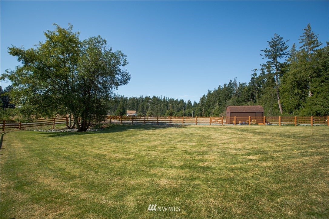12057 Havekost Road Anacortes, WA 98221 - Photo 35 of 40 a front view of a house with a yard and trees