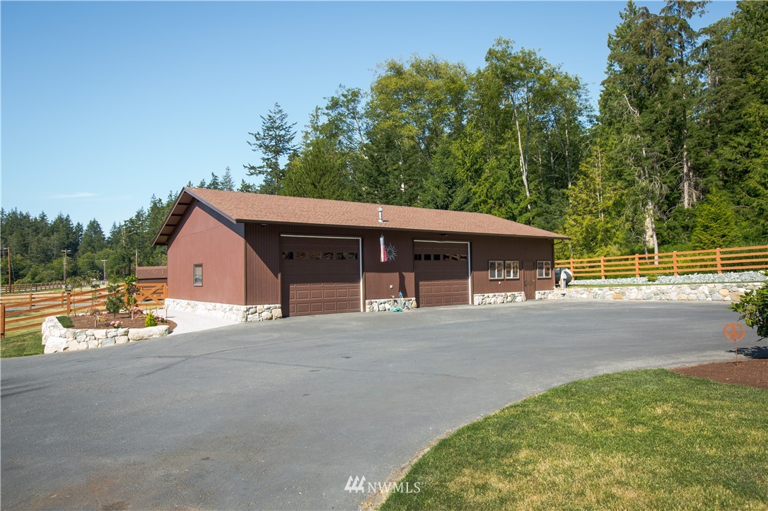 12057 Havekost Road Anacortes, WA 98221 - Photo 36 of 40 a front view of a house with a yard and garage