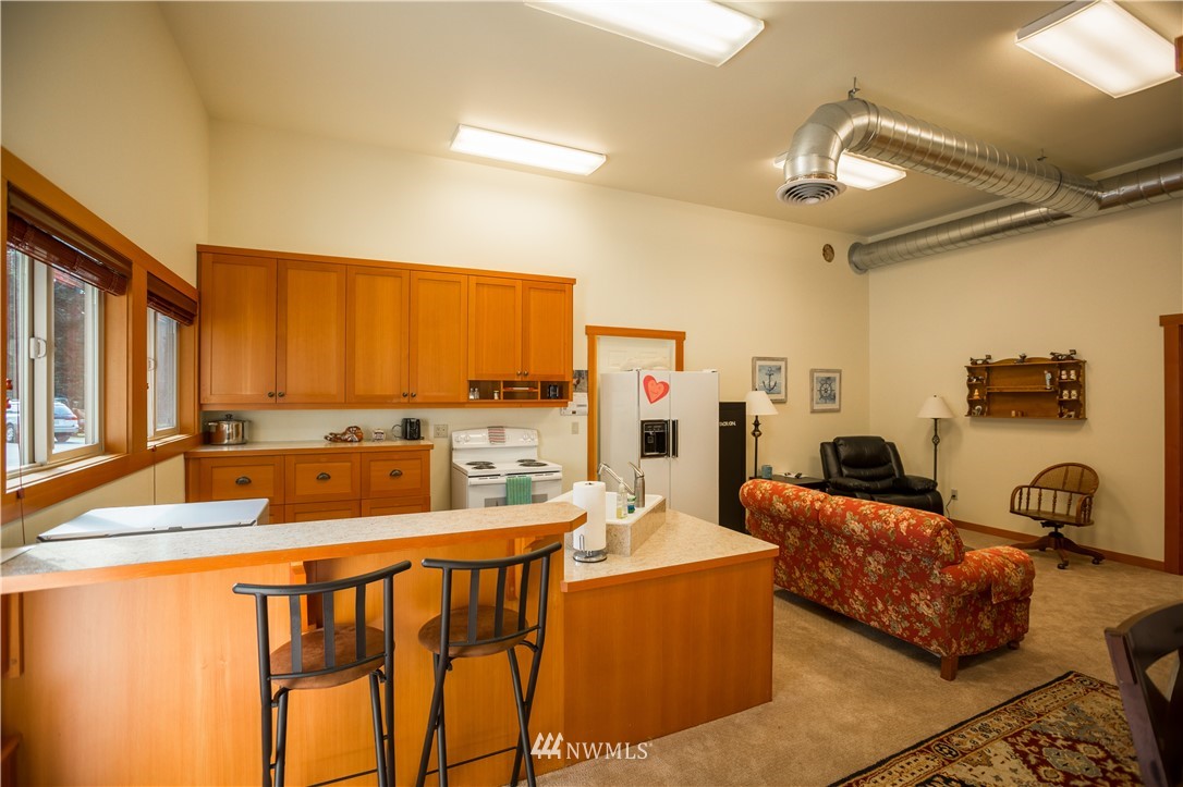 12057 Havekost Road Anacortes, WA 98221 - Photo 37 of 40 a living room with furniture kitchen view and a large window