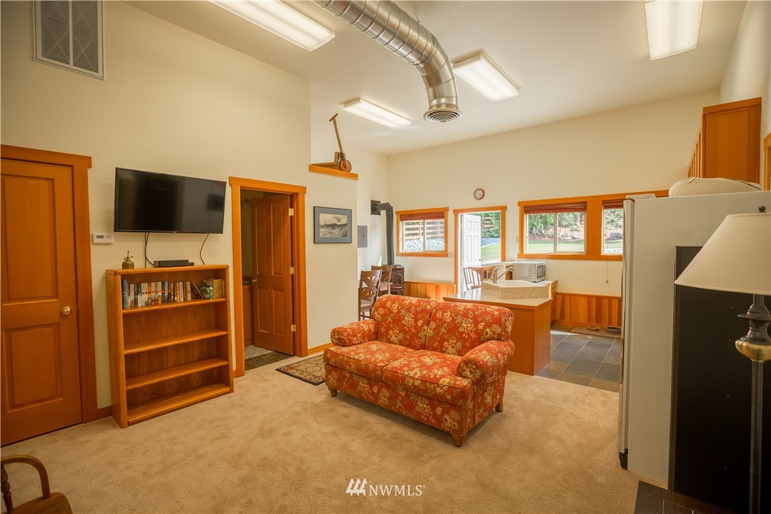 12057 Havekost Road Anacortes, WA 98221 - Photo 38 of 40 a living room with furniture and a flat screen tv