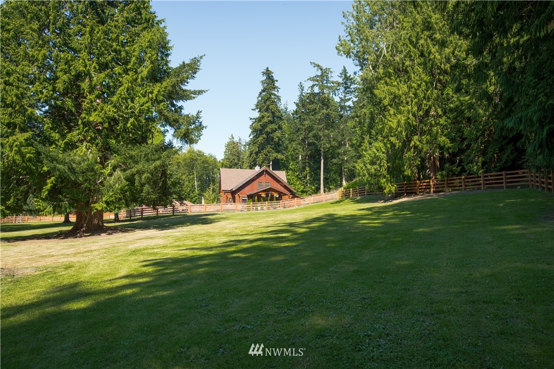 12057 Havekost Road Anacortes, WA 98221 - Photo 9 of 40 a view of a swimming pool with a garden and trees
