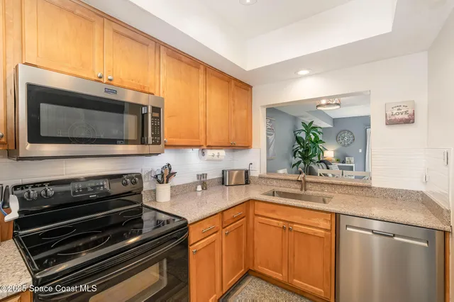 a kitchen with sink a microwave and cabinets
