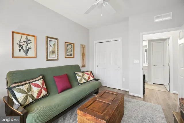 a view of a livingroom with lounge chair and a window