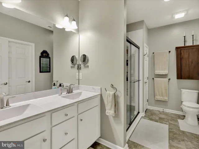 a spacious bedroom with a bed couch and a window