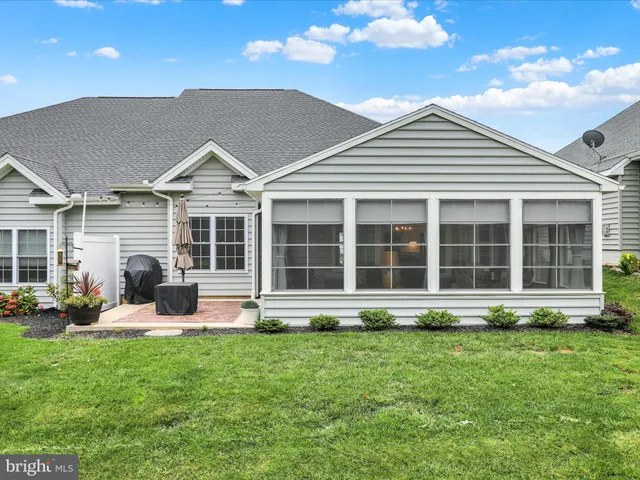 a front view of a house with a yard table and chairs