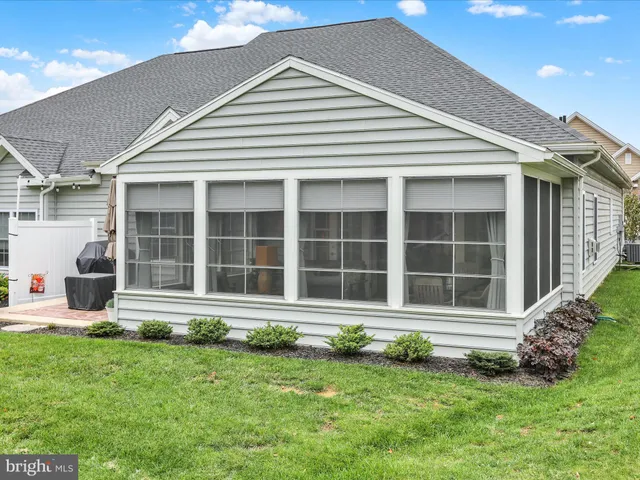 a living room with furniture and large windows