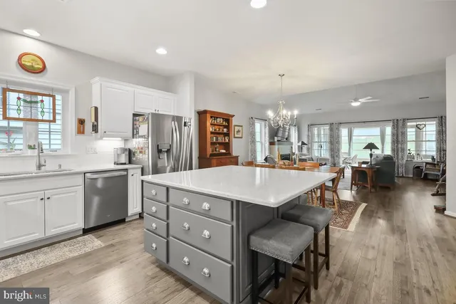 a kitchen with a sink refrigerator and cabinets