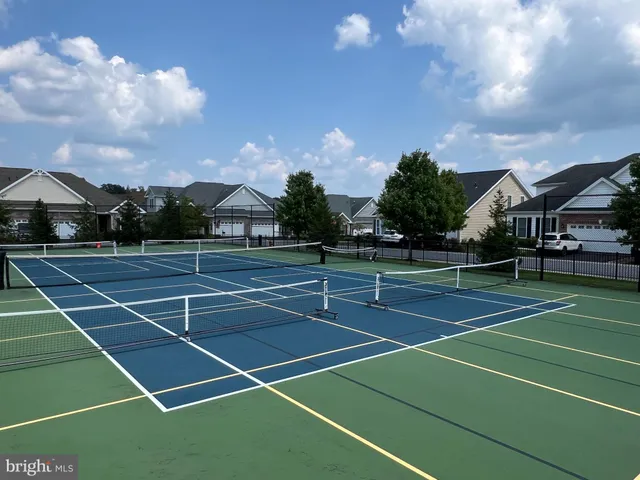 a living room with furniture and large windows