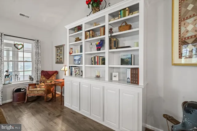 a living room with furniture cabinets and a bookshelf
