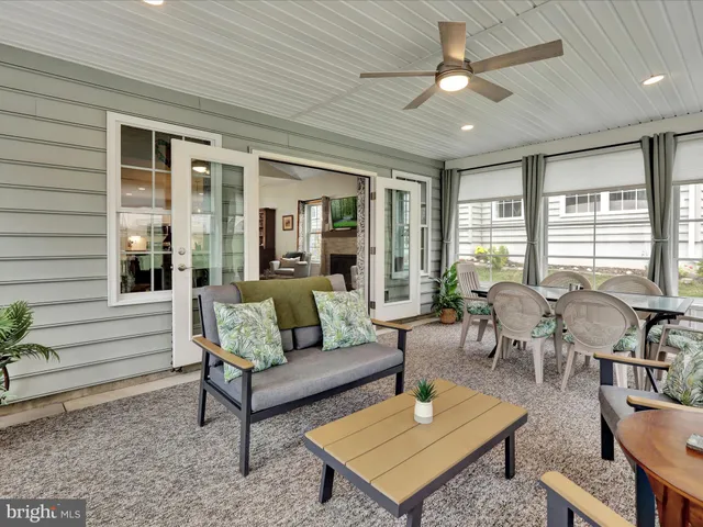 a living room with furniture a table and a large window