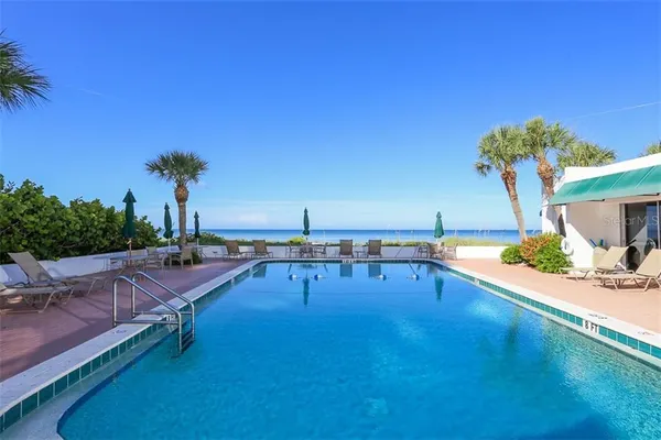 a view of a swimming pool with an outdoor seating