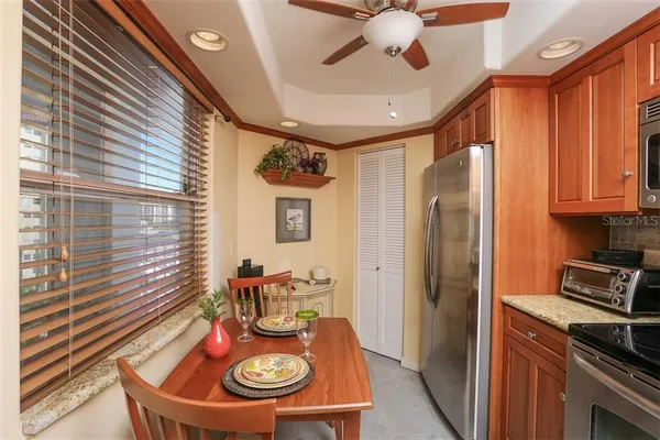 a kitchen with stainless steel appliances granite countertop a refrigerator and a sink