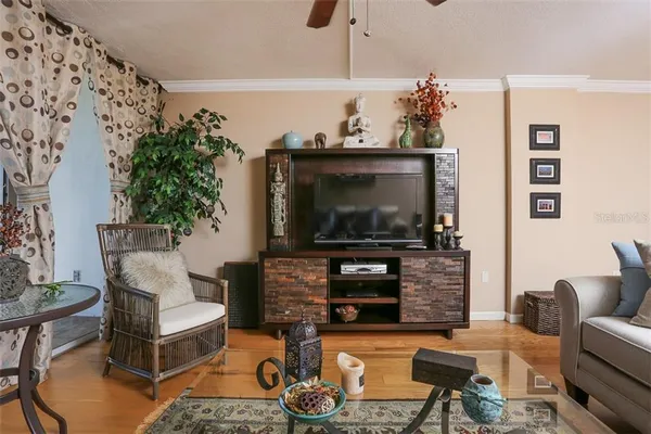 a living room with furniture a flat screen tv and a fireplace
