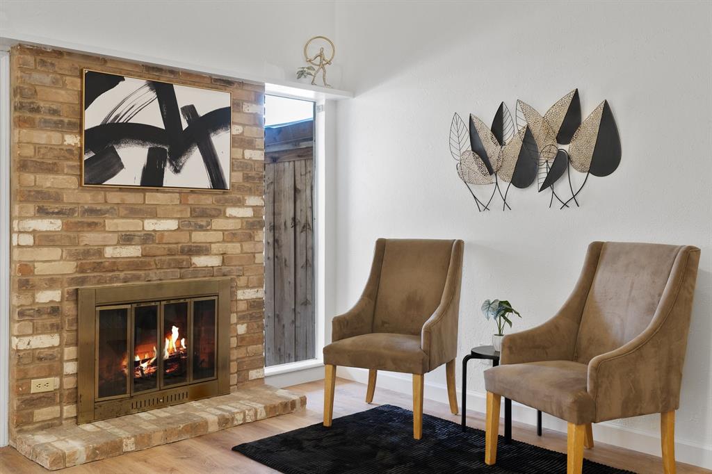 2009 Sandberg Drive, Unit 159 Austin, TX 78752 - Photo 8 of 28 Cozy fireplace anchors the main living space