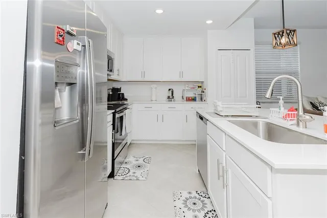 a kitchen with a refrigerator and a sink