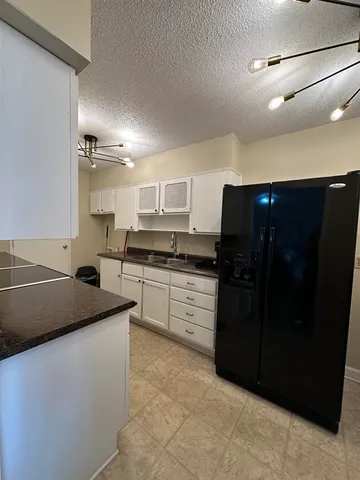 a kitchen with a sink and white cabinets