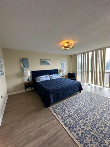 a bedroom with bed and window