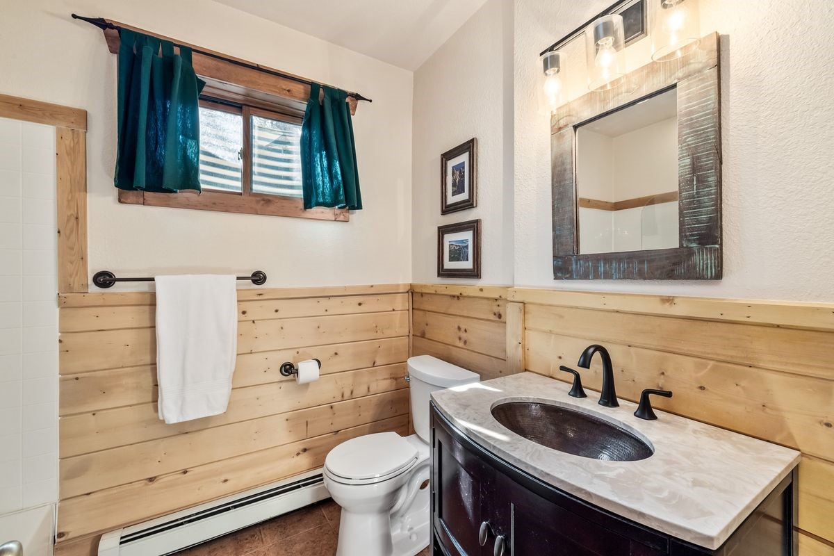 999 Bowstring Como, CO 80456 - Photo 29 of 37 a bathroom with a sink a toilet and mirror