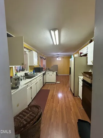 a kitchen with sink cabinets and appliances