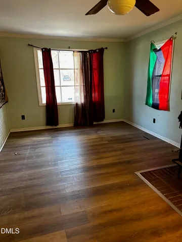 wooden floor in an empty room with a window