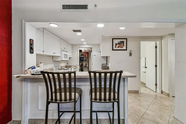 a kitchen with kitchen island a stove a sink and a refrigerator