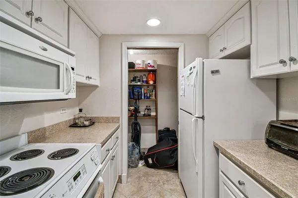 a kitchen with granite countertop a sink cabinets stainless steel appliances and a window
