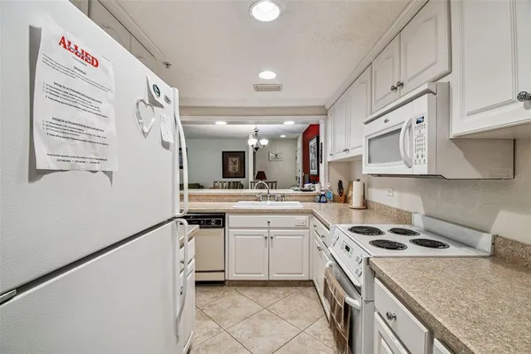 a kitchen with a stove a sink and a microwave
