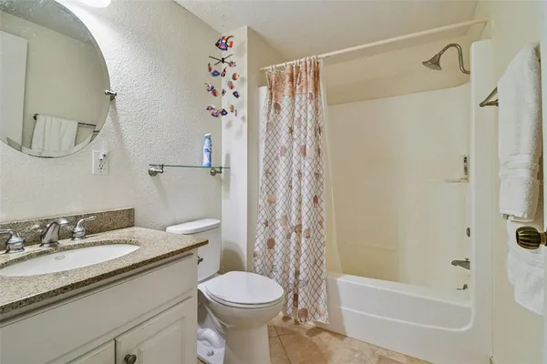 a bathroom with a shower curtain and a shower curtain