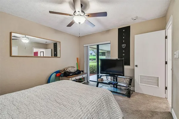 a bedroom with bed and a chandelier