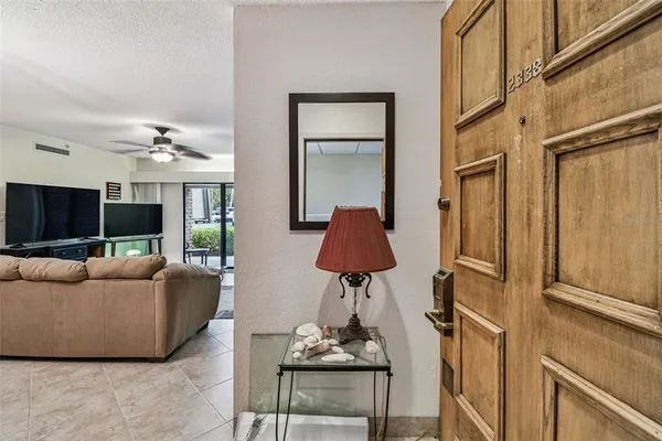 a living room with furniture a chandelier and a flat screen tv