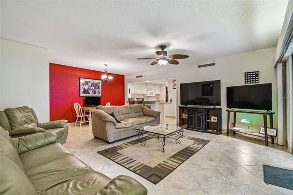 a living room with furniture a rug and a window