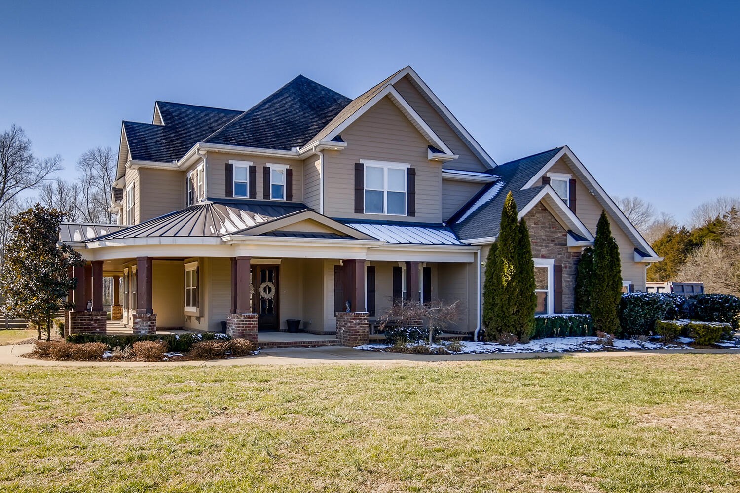 a front view of a house with swimming pool and furniture