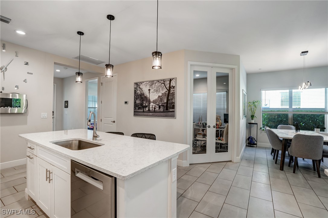 7028 Mistral Way Fort Myers, FL 33966 - Photo 11 of 37 a kitchen with a sink a counter and chairs