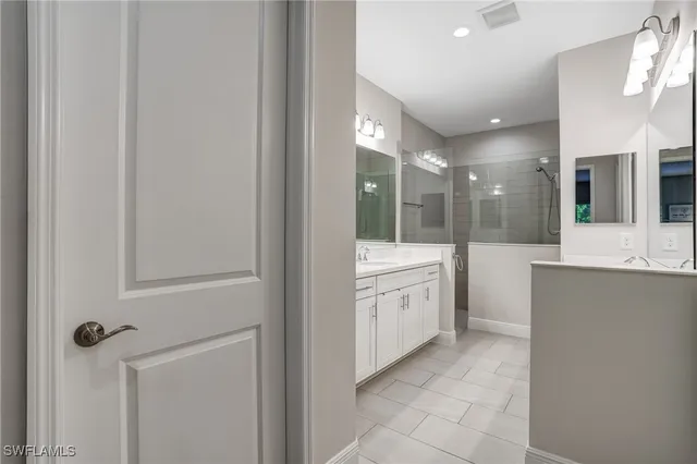 a large bathroom with a double vanity sink and mirror