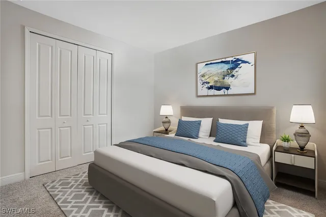 a bedroom with a bed and a painting on the wall