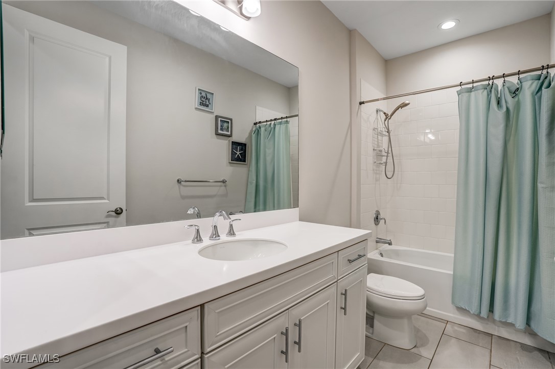 7028 Mistral Way Fort Myers, FL 33966 - Photo 20 of 37 a bathroom with a sink a mirror a toilet and shower