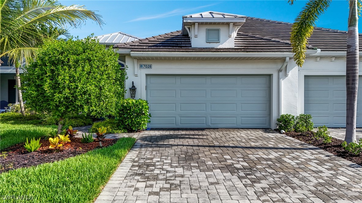 7028 Mistral Way Fort Myers, FL 33966 - Photo 30 of 37 a front view of a house with a yard