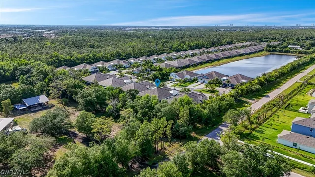 an aerial view of residential houses with outdoor space and swimming pool
